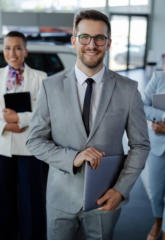 salesteam-in-dealership-three-beautiful-consultants-or-managers-in-elegant-suit-looking-on-camera-1-1.jpg